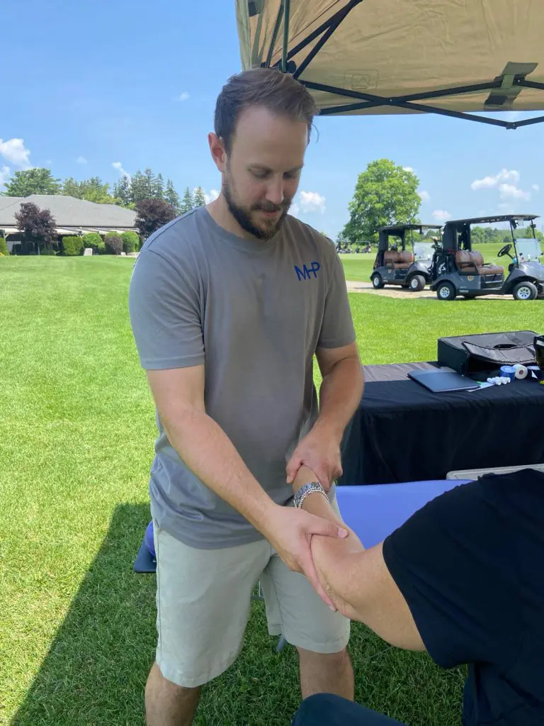 Massage Therapist working on patient at golf tournament